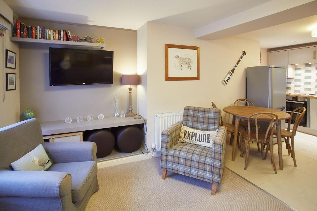 a living room with a couch and a table and a tv at Host & Stay - Spyglass 1708 in Whitby