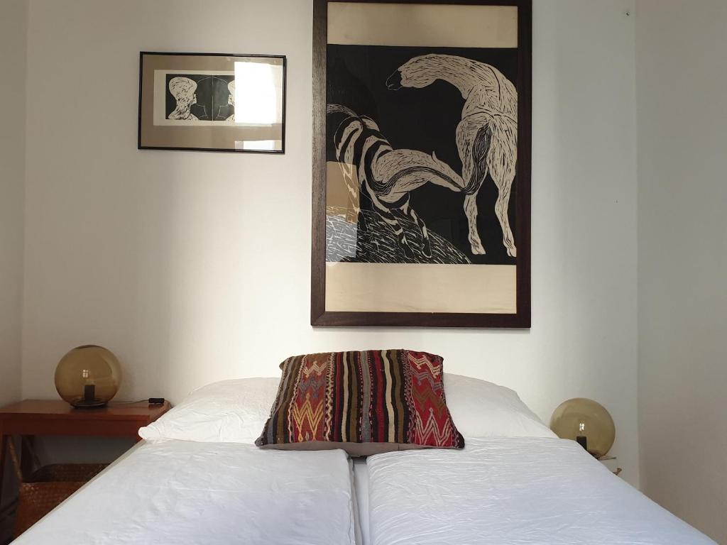 a white bed with a blanket on top of it at Apartment center Friedrichshain in Berlin