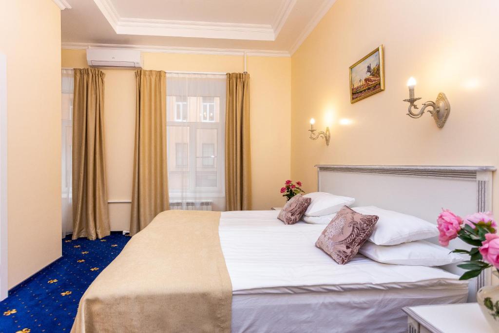 a hotel room with a bed and a window at Casa Leto in Saint Petersburg