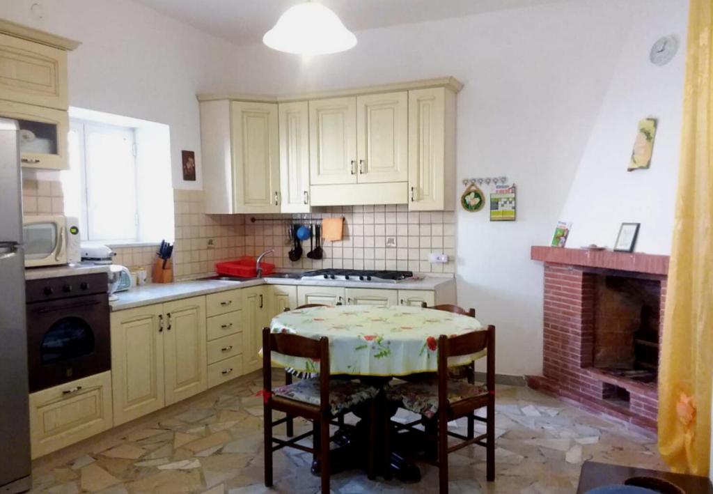 a kitchen with a table and a stove at GIARDINO SUL MARE in Amalfi