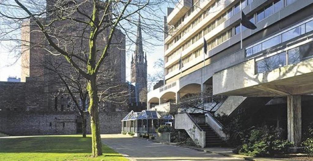 un edificio e un albero accanto a un edificio di Britannia Hotel Coventry a Coventry