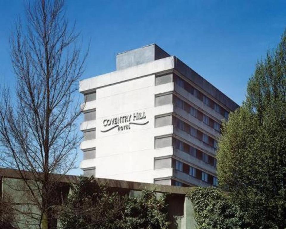 a building with a sign on the side of it at Coventry Hill Hotel in Coventry