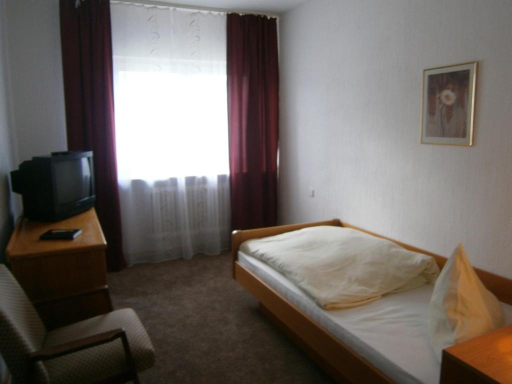Postel nebo postele na pokoji v ubytování Hotel Strauss