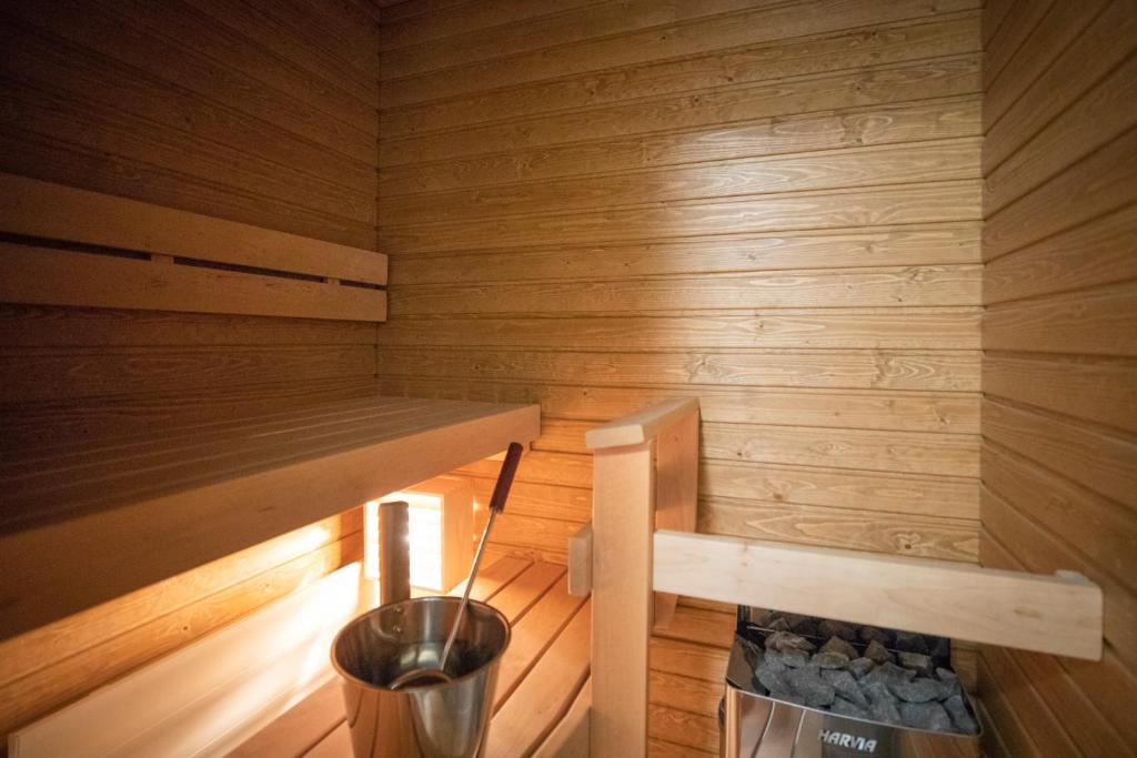 a small sauna with a trash can in it at Arctic Penthouse City Suite in Rovaniemi