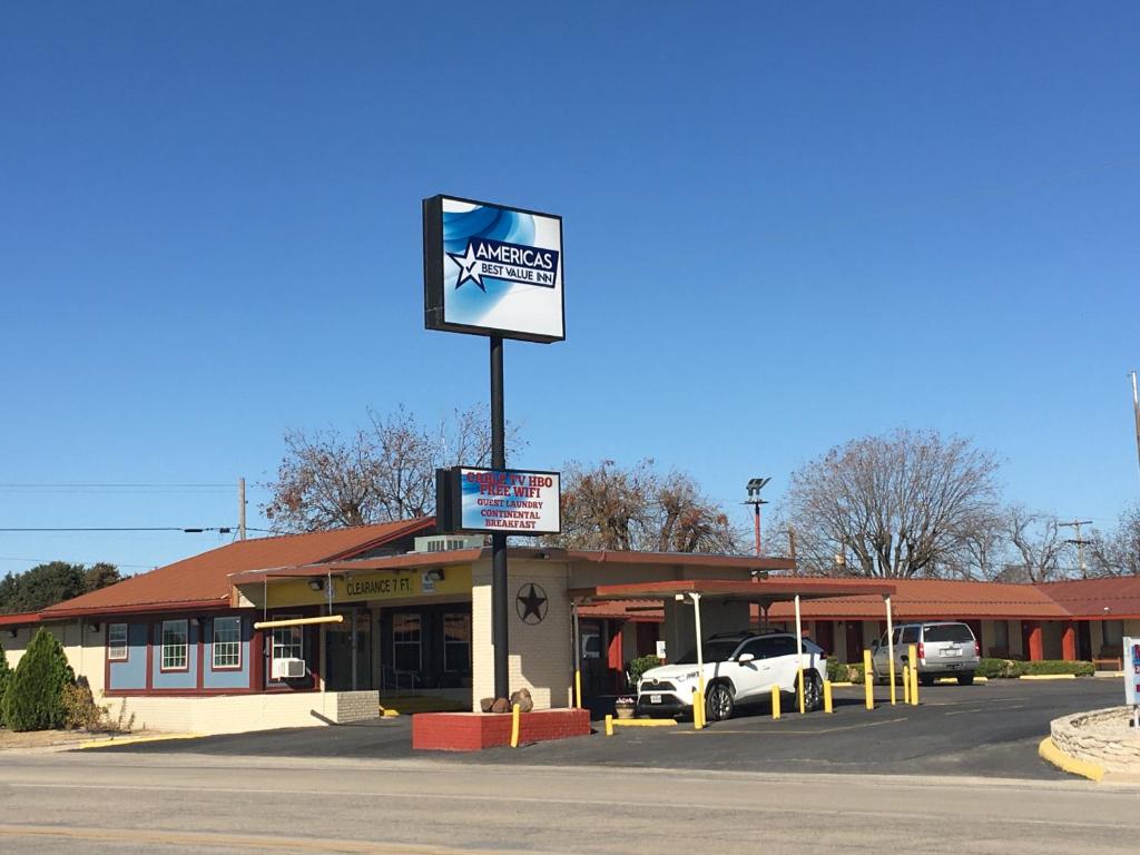 a gas station with a sign in front of it at Americas Best Value Inn Ozona in Ozona
