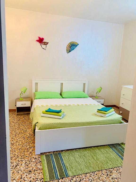 a bedroom with a bed and two kites on the wall at Green Apartment in Rosolina Mare