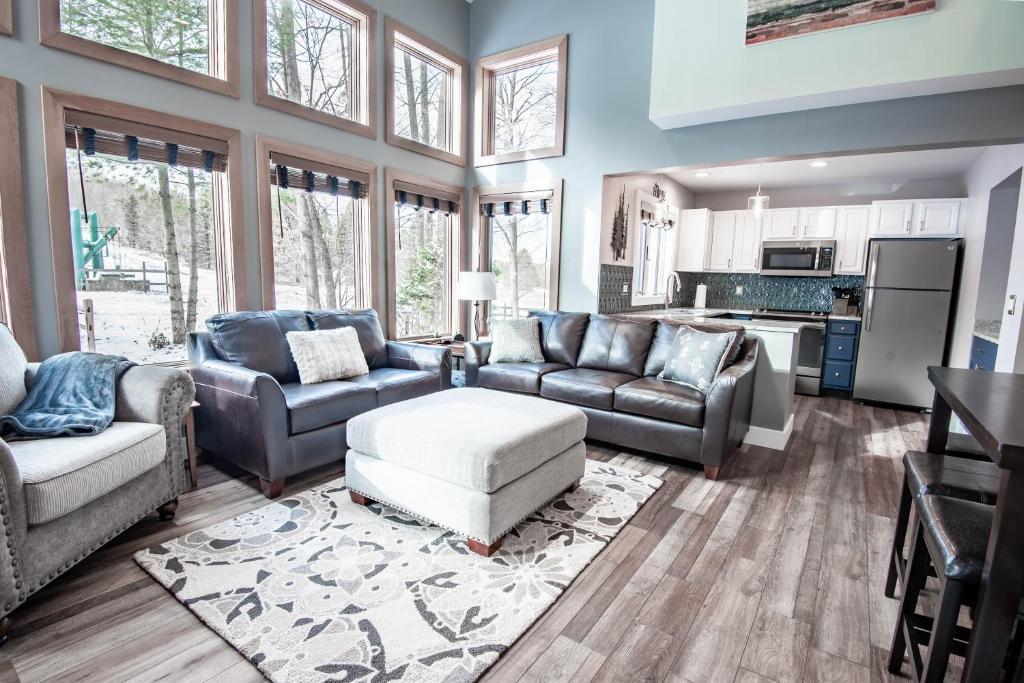a large living room with couches and a kitchen at 652 Disciples Village in Boyne Falls