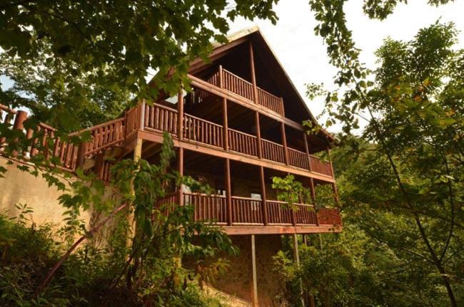 a large building with a deck in the trees at #1850 Amazing Smoky Views in Williamsburg