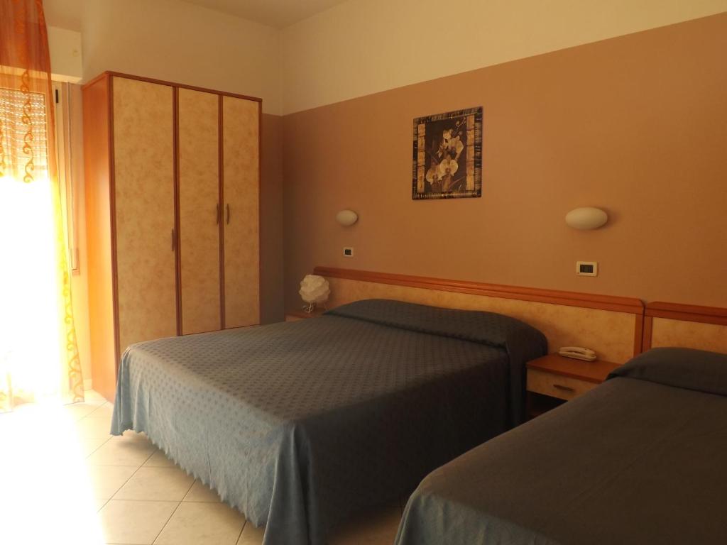 Un pat sau paturi într-o cameră la Hotel Danubio