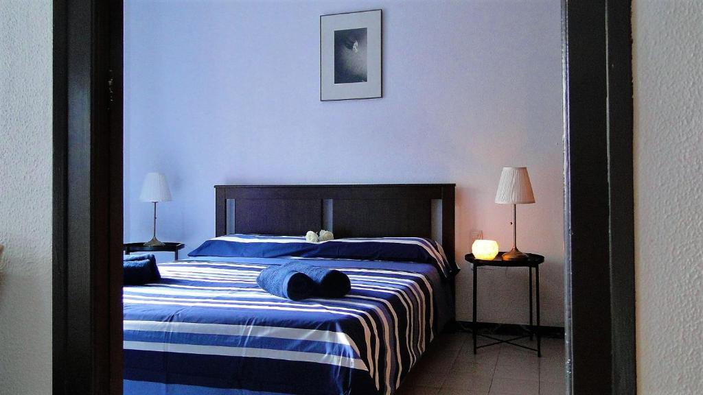 a bedroom with a large bed with blue sheets at Ca La Roseta in Castellfollit de la Roca