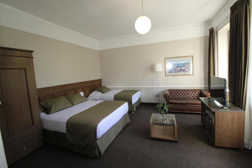 Llit o llits en una habitació de Hotel Casagrande