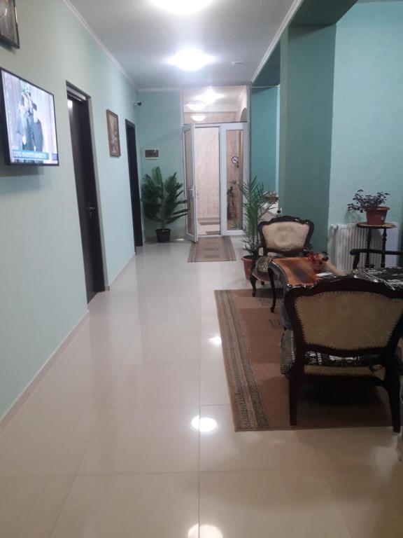 a hallway with couches and chairs in a building at Keba in Tbilisi City