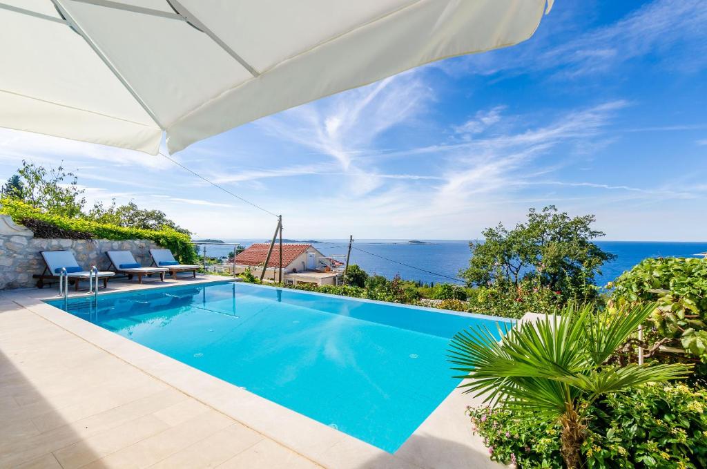 a villa with a swimming pool and a view of the ocean at Villa Art Gallery in Mlini
