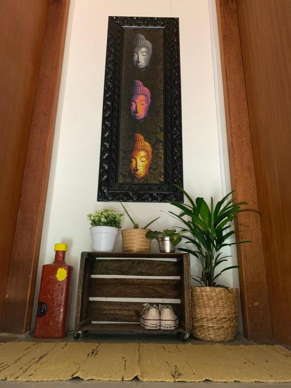 a picture of a woman on a wall with plants at BeMyGuest Floripa in Florianópolis
