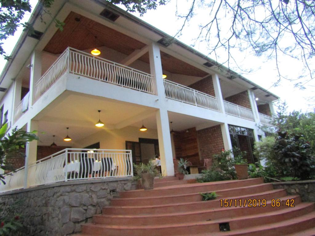 a large house with stairs in front of it at Hospitality Connect in Kampala