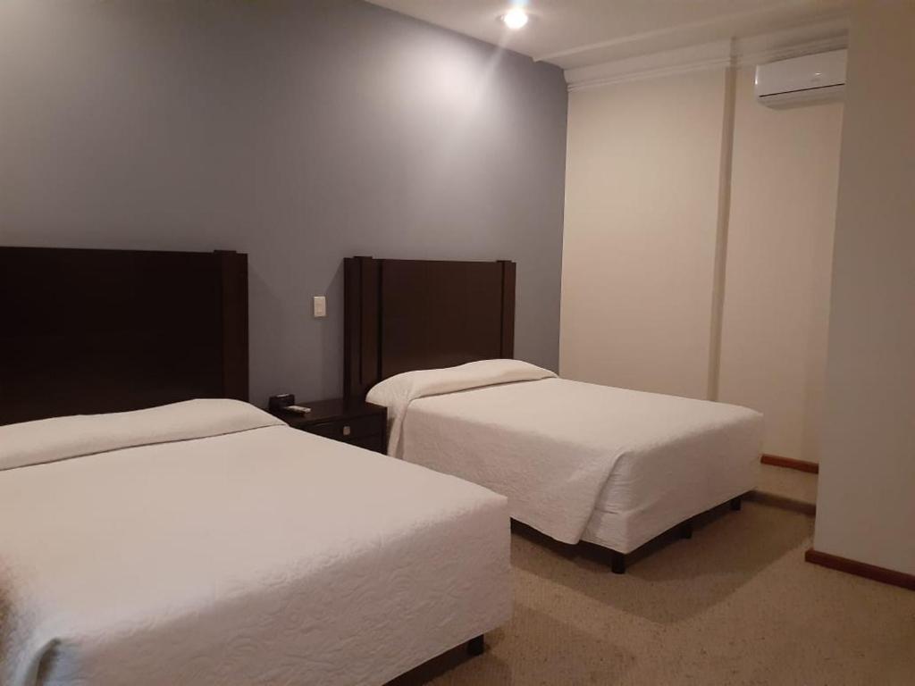 Postel nebo postele na pokoji v ubytování HOTEL CANDELERO