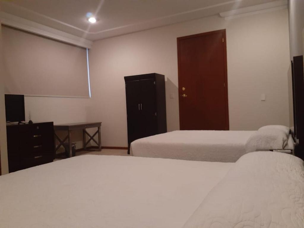 Postel nebo postele na pokoji v ubytování HOTEL CANDELERO