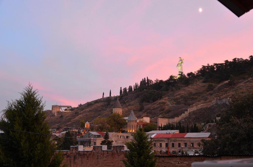 a city with a statue of liberty on a hill at Natia's apartment on Dadiani st. in Tbilisi City