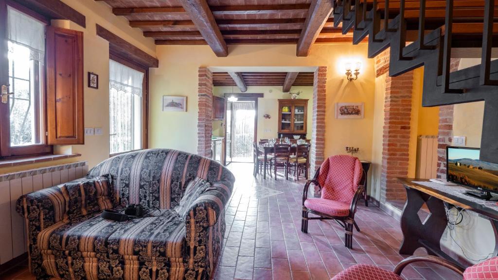 a living room with a couch and two chairs at La Cascina in Castiglione del Lago