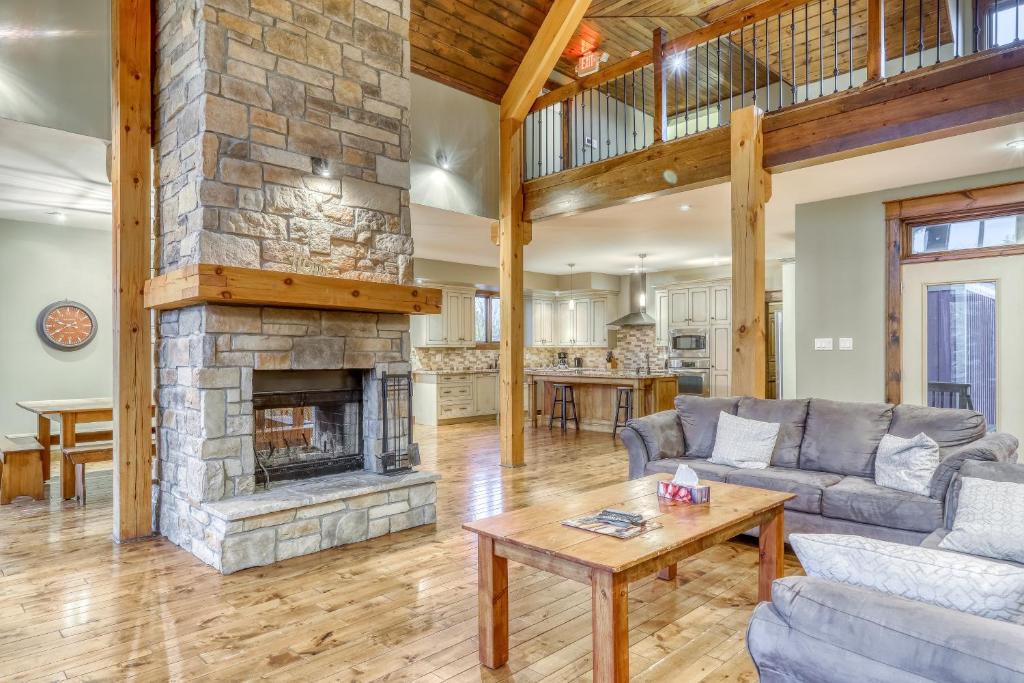 a living room with a stone fireplace at Lucille 109 in Blue Mountains