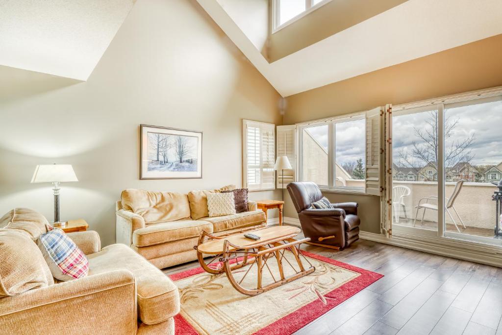 a living room with two couches and a table at Wintergreen 223 in Blue Mountains