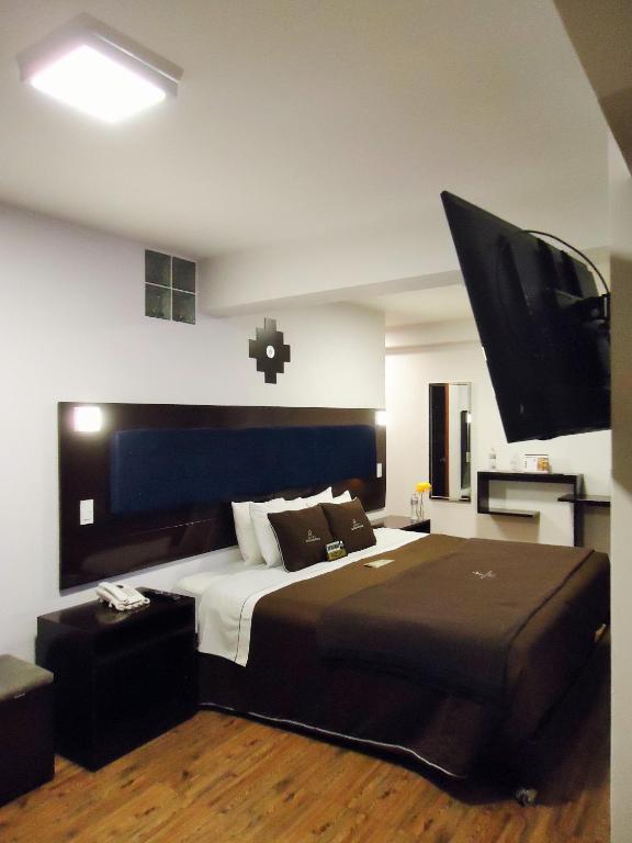 Postel nebo postele na pokoji v ubytování San Francisco Cusco Hotel