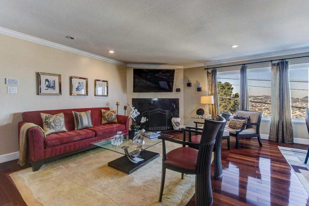 a living room with a red couch and a table at House-Canyon Dr in Oceanview