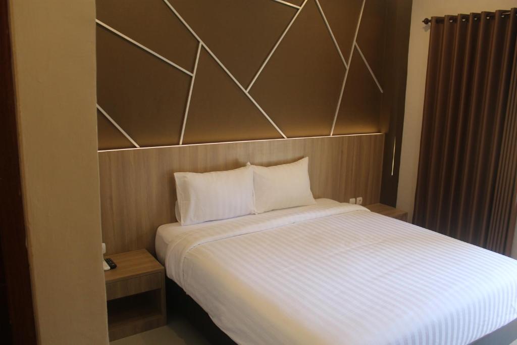 Postel nebo postele na pokoji v ubytování Grand Kuta Hotel