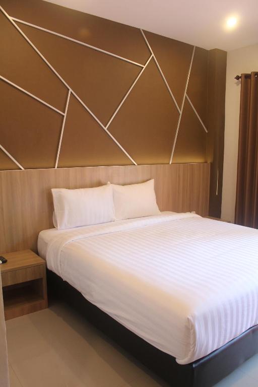 A bed or beds in a room at Grand Kuta Hotel