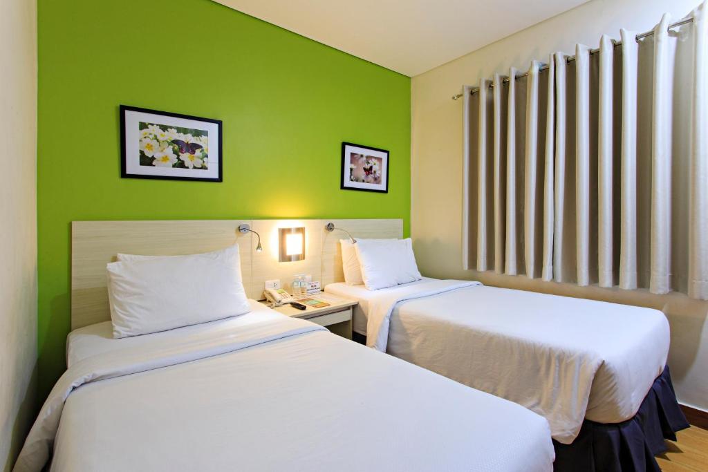 Postel nebo postele na pokoji v ubytování Hamersons Hotel Cebu