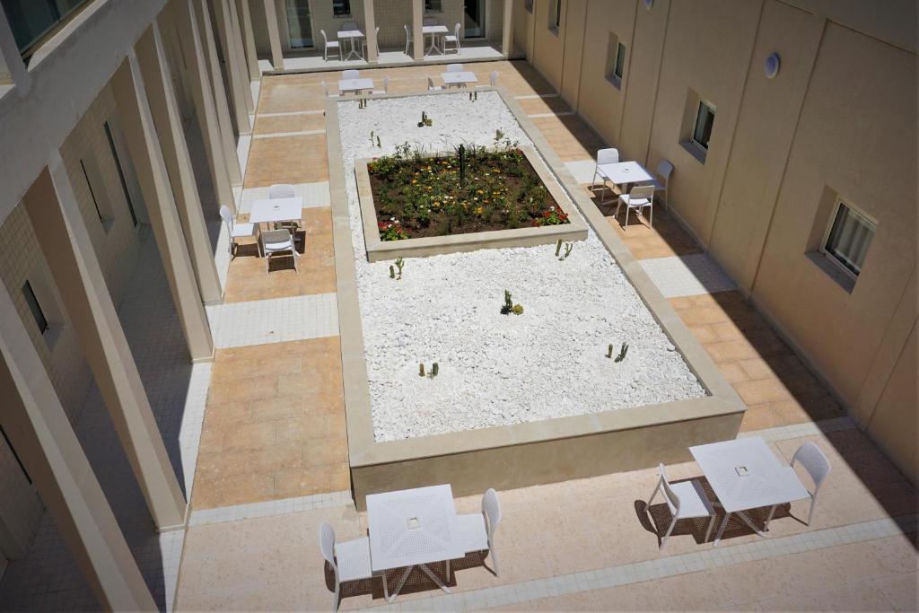 an overhead view of a building with tables and chairs at ONOMO Hotel Tanger Med in Tangier