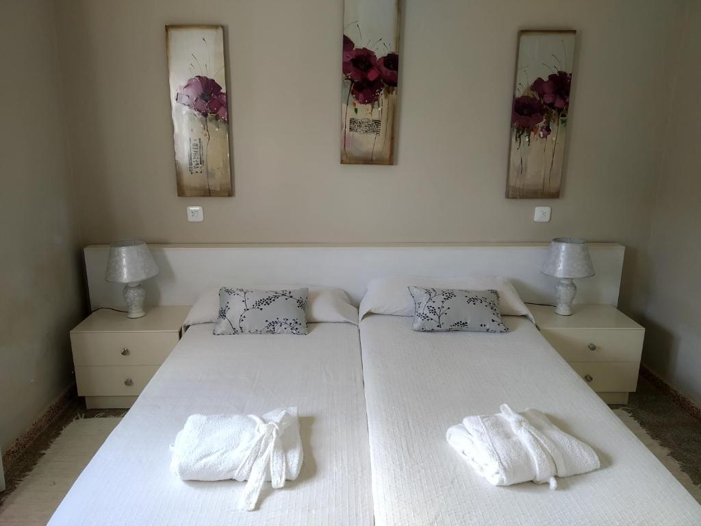 a bedroom with two beds with towels on them at Casa Rosella in Sant Ferran de Ses Roques