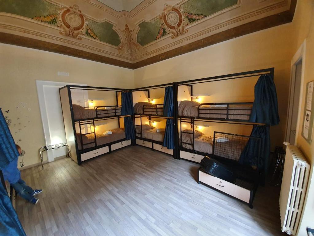 an overhead view of a room with four bunk beds at CconfortHotels Host Bari Centrale SELF CHECK IN in Bari