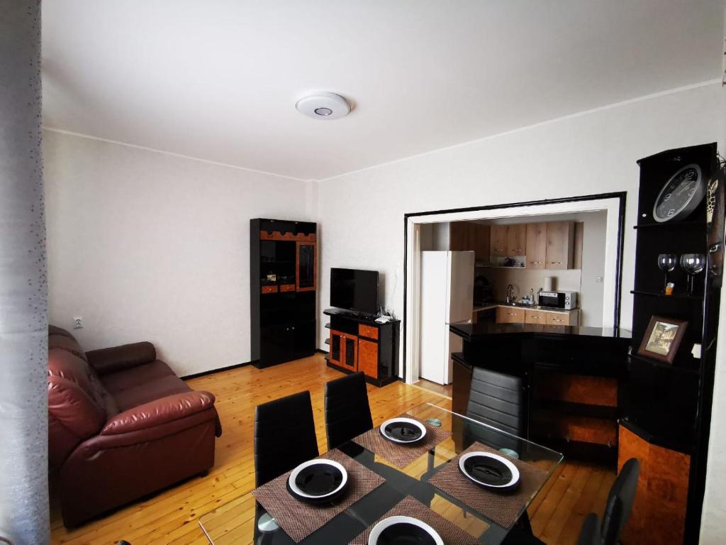 a living room with a table and a couch at Serdika station, bright and cozy apartment in Sofia