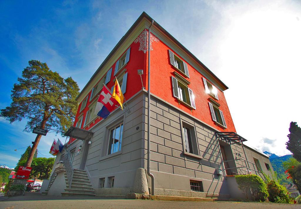 a building with flags on the side of it at Gasthaus zur Waldegg in Luzern