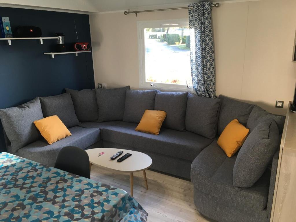 a living room with a couch and a table at CampingKer in Pont-Aven