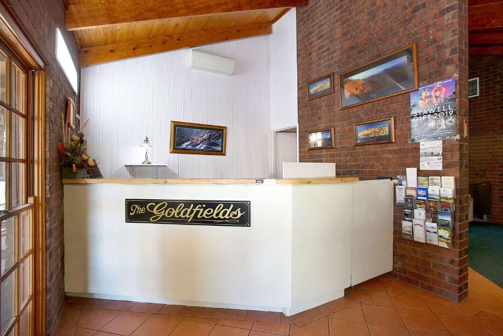 a room with a wall of drawers and a painting on the wall at Goldfields Motel in Stawell