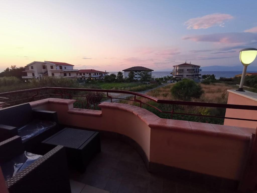 a view of a sunset from the balcony of a house at Residence La Torretta Briatico - Tropea in Briatico