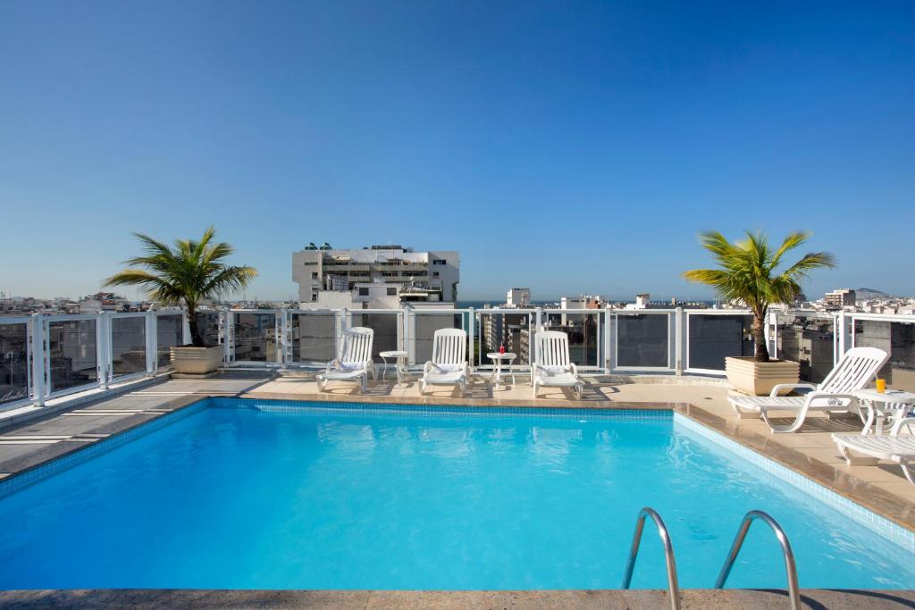 a swimming pool on the roof of a building at Hotel Atlântico Copacabana in Rio de Janeiro