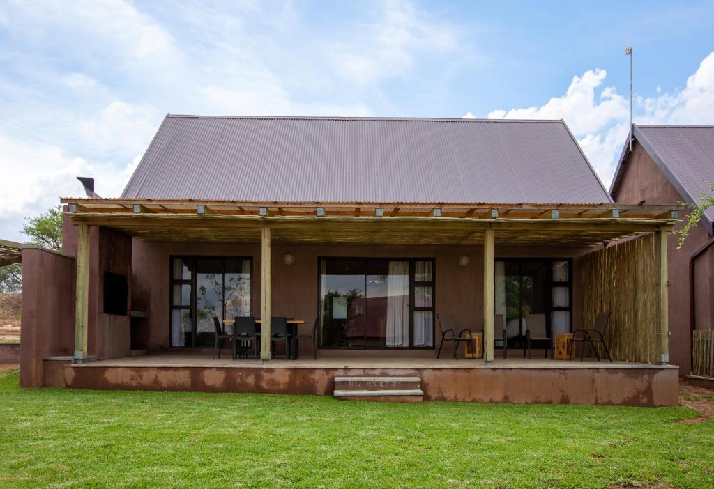 a small house with a metal roof at The Cottage in Hoedspruit