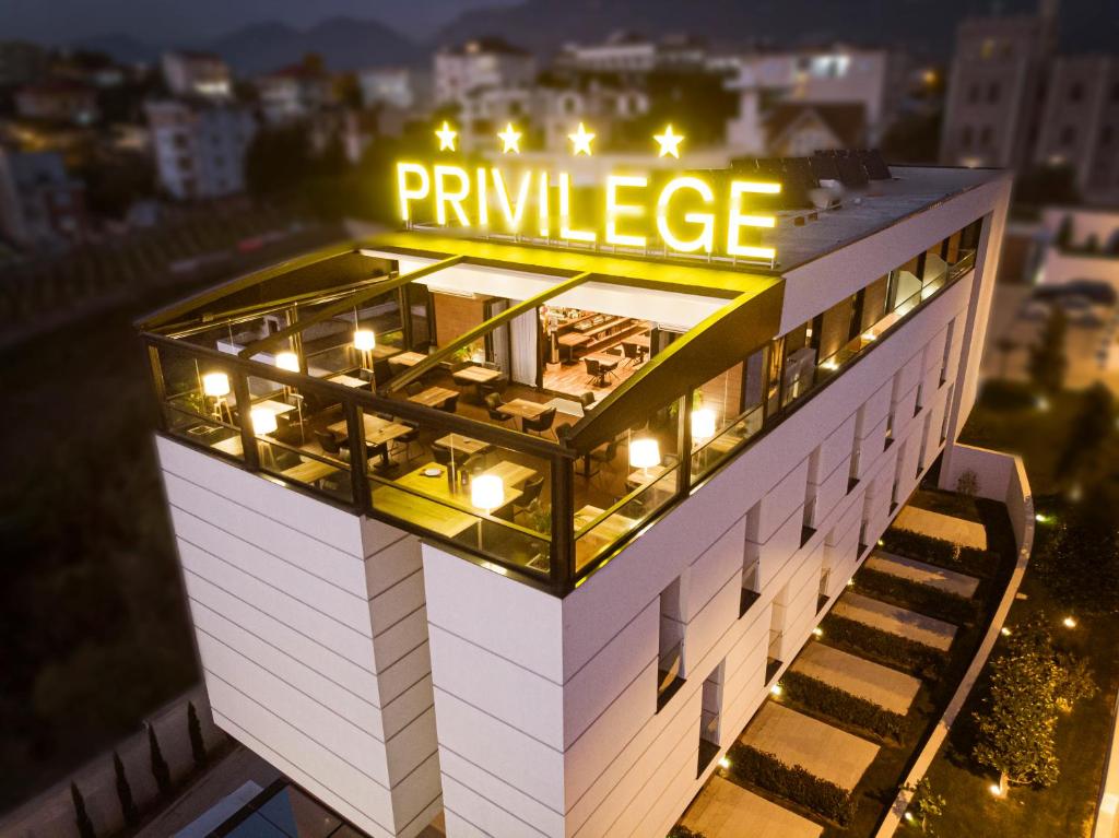 a building with a pharmacy sign on top of it at Privilege Hotel & Spa in Tirana