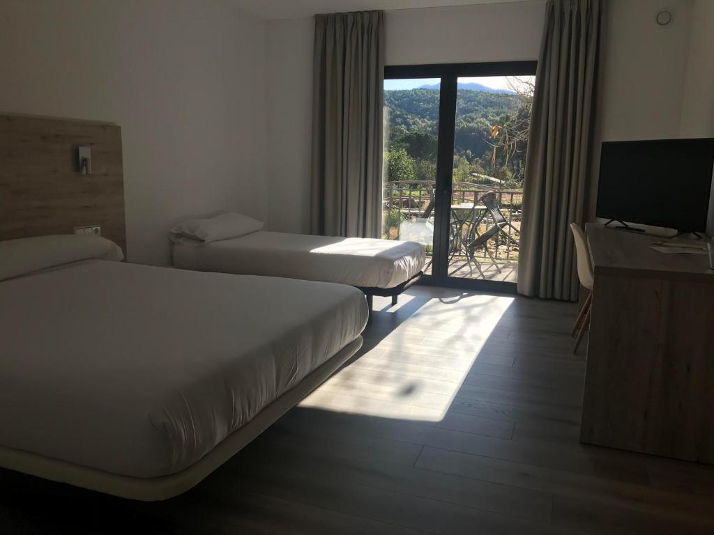 Postel nebo postele na pokoji v ubytování Hostal La Guineu