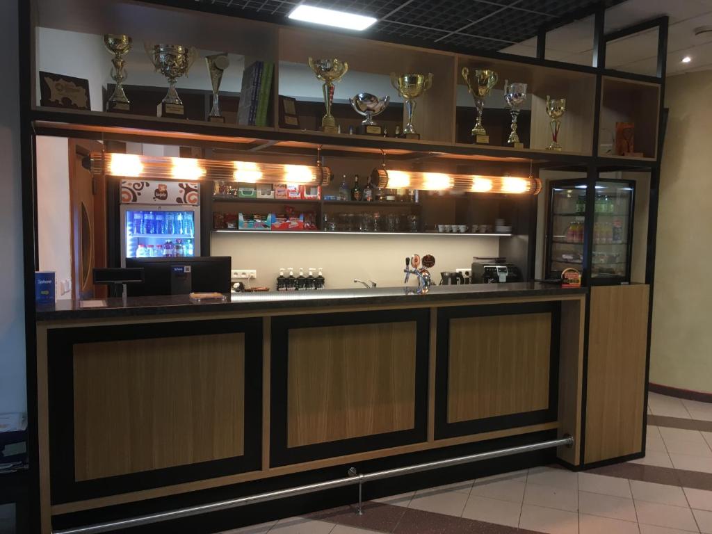 a bar in a restaurant with trophies on the shelves at Imet Centrum in Bratislava