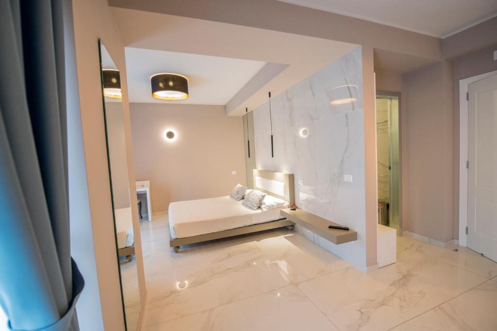 Duży pokój z łóżkiem i lustrem w obiekcie Milazzo Aeolian Sea Port B&B w mieście Milazzo