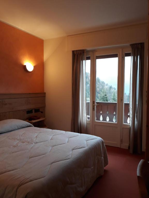 Postel nebo postele na pokoji v ubytování Albergo Piazzatorre