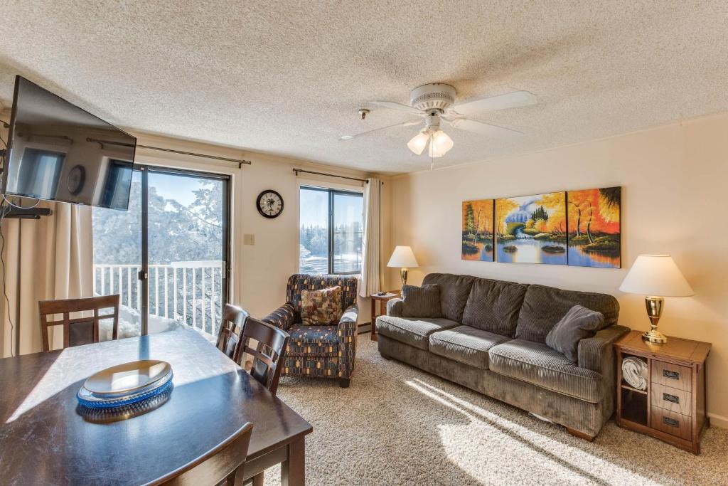 a living room with a couch and a table at Stroll to Slopes, Village Area, Ski in-out MtLodge 329 in Snowshoe