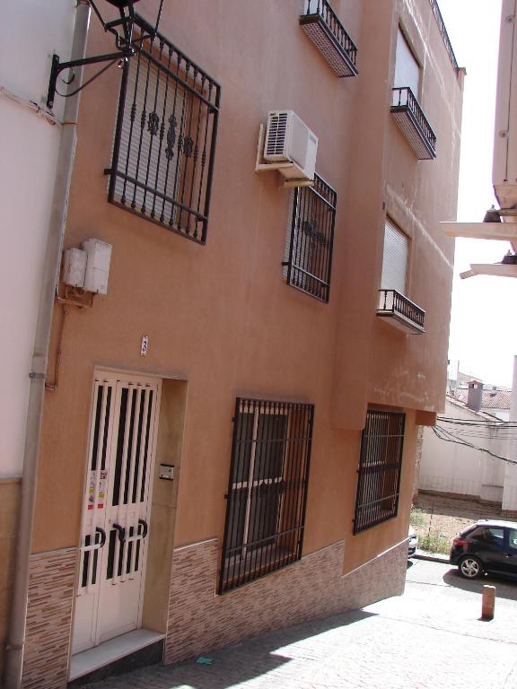 a building with barred windows and a white door at Casa Gazquez in Santo Tomé