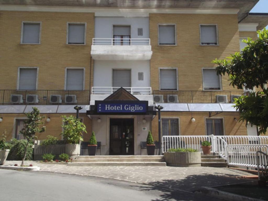 a building with a hotel sign in front of it at Albergo Giglio in Chianciano Terme