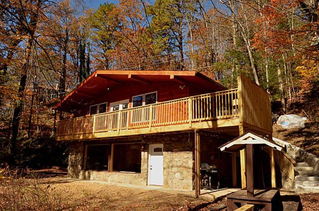 a house with a deck on top of it at #820 Honeymoon Hideaway in Gatlinburg