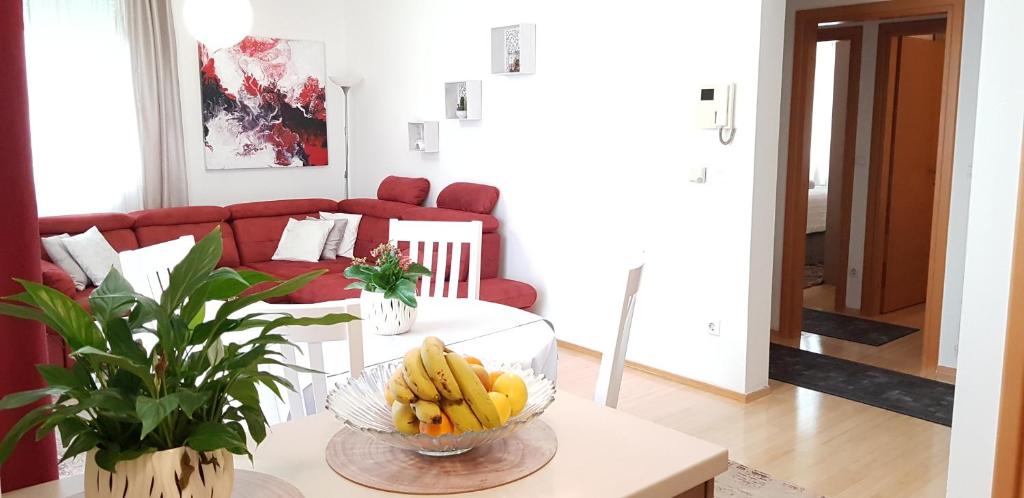 a living room with a bowl of bananas on a table at Apartman ARINA in Zagreb
